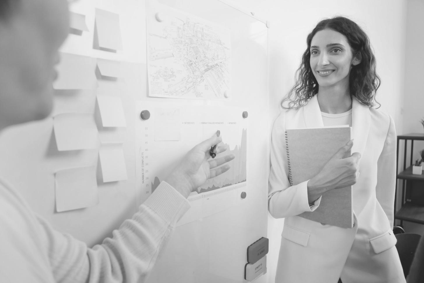 Professional training environment showing modern classroom setup with multiple monitors displaying backup system architectures
